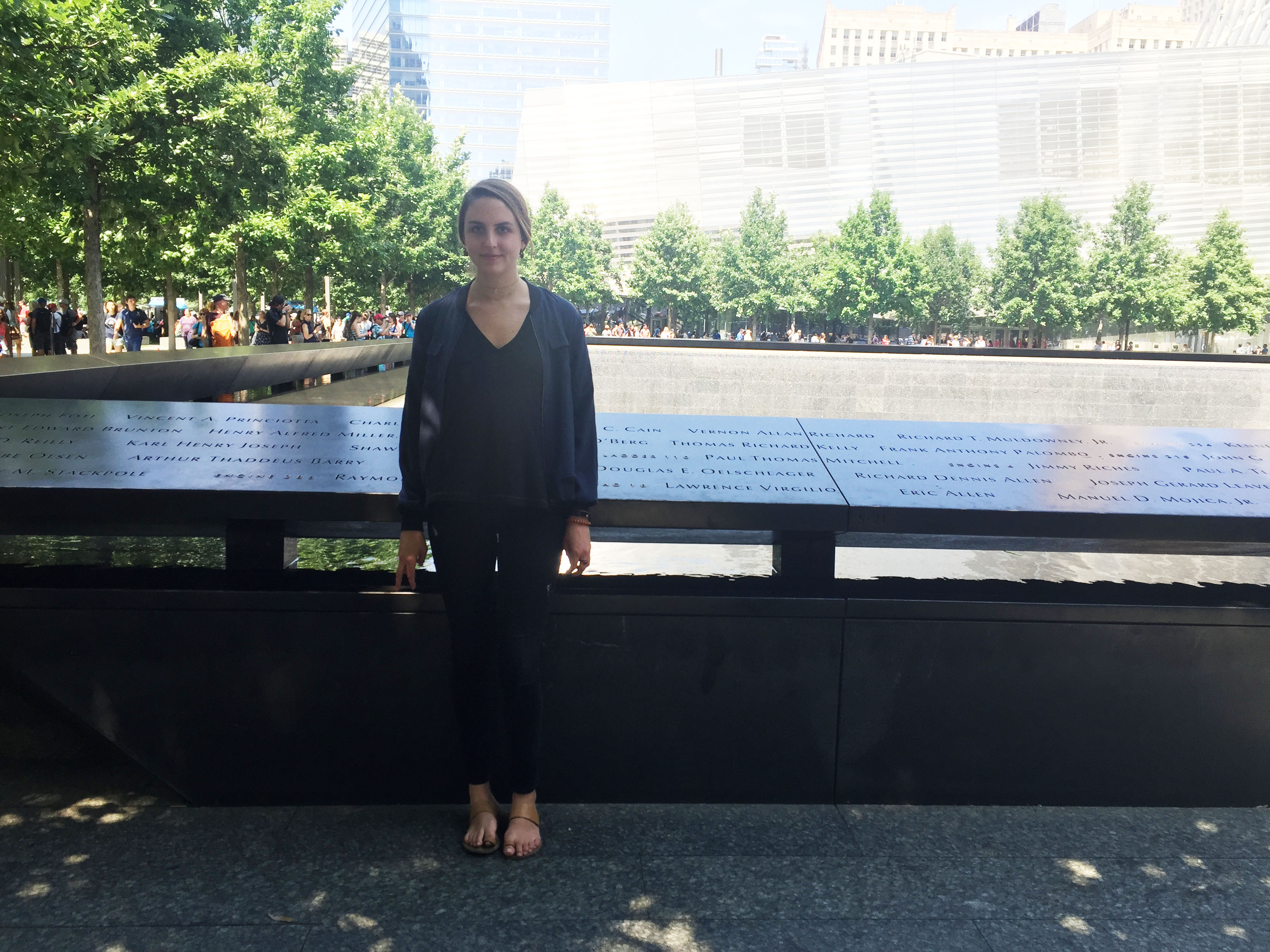 Madeline Lipton, a communications intern, poses for a photo on the 9/11 Memorial Plaza.