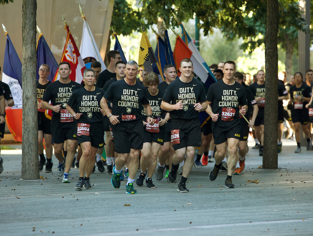 West Point Cadets run in formation at the 9/11 Memorial.
