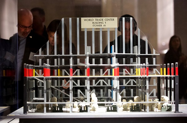 Visitors observe a model of the damaged World Trade Center parking garage in Foundation Hall at the Museum.