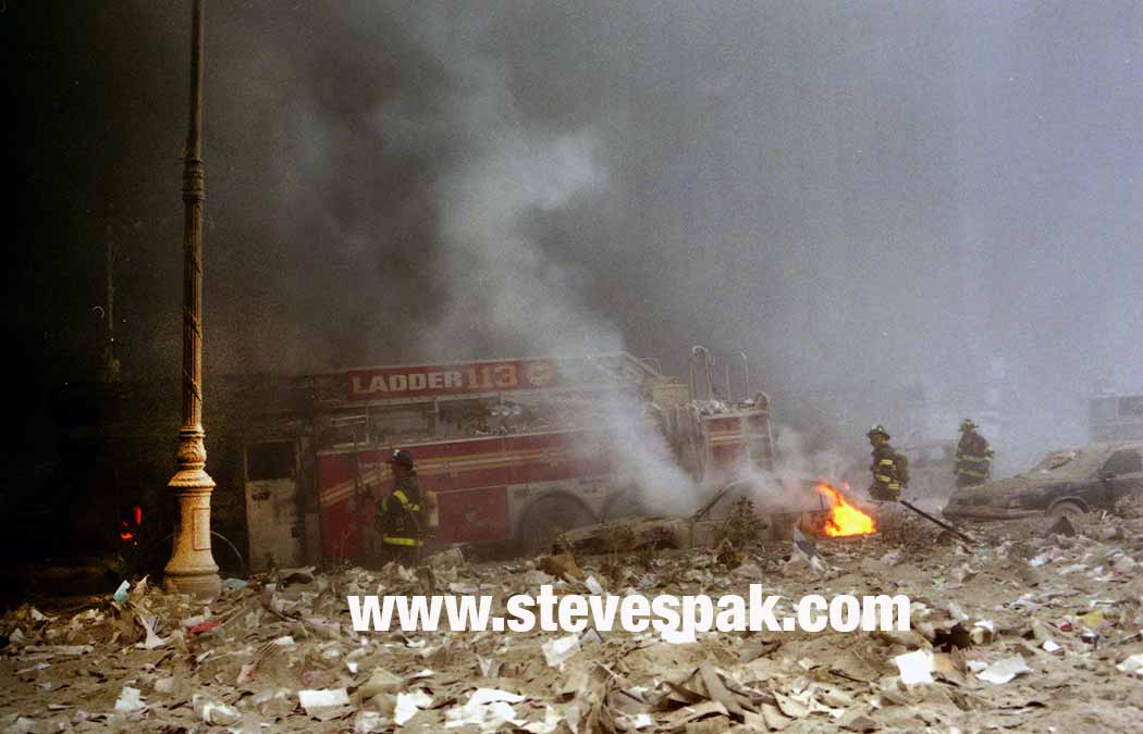 FDNY Ladder Company 113 is on fire. Firefighters using fire extinguishers are trying to put the fire out.