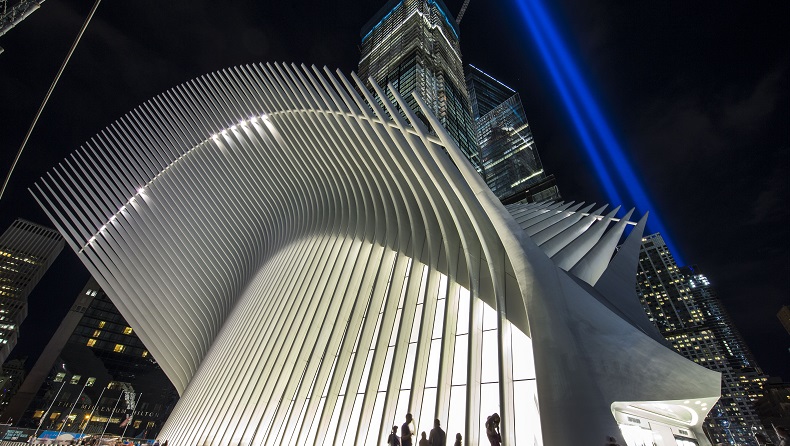 The annual Tribute in Light shines behind the Oculus at night.