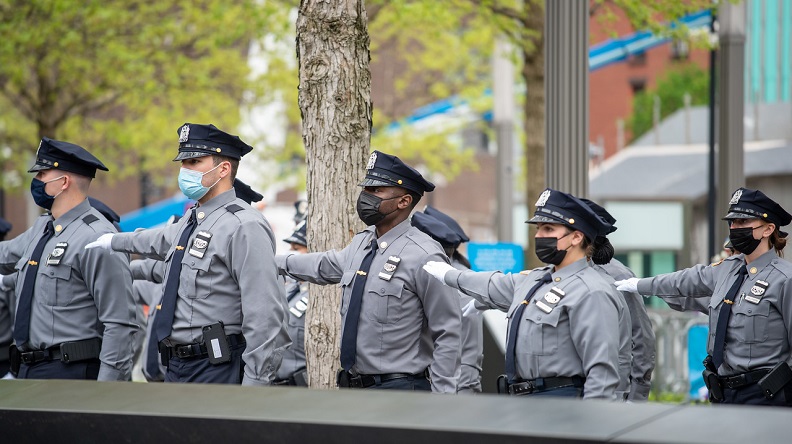 NYPD recruits stand at arm's length on the Memorial plaza during a recruitment ceremony.