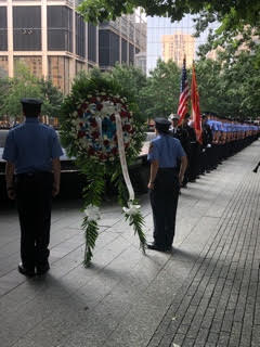 Uniformed members of the FDNY and probationary EMTs lay a wreath at the Memorial.