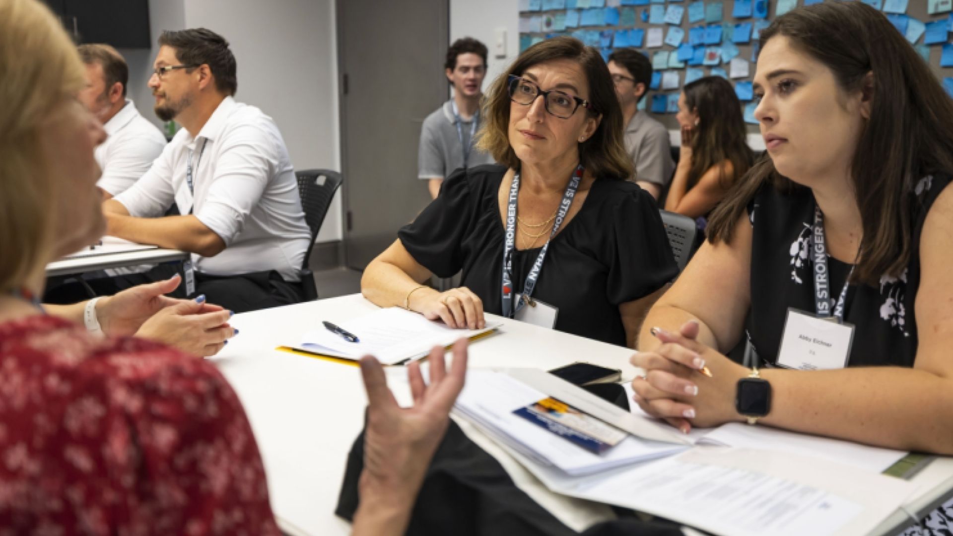 Educators in a discussion at a table during a PD session