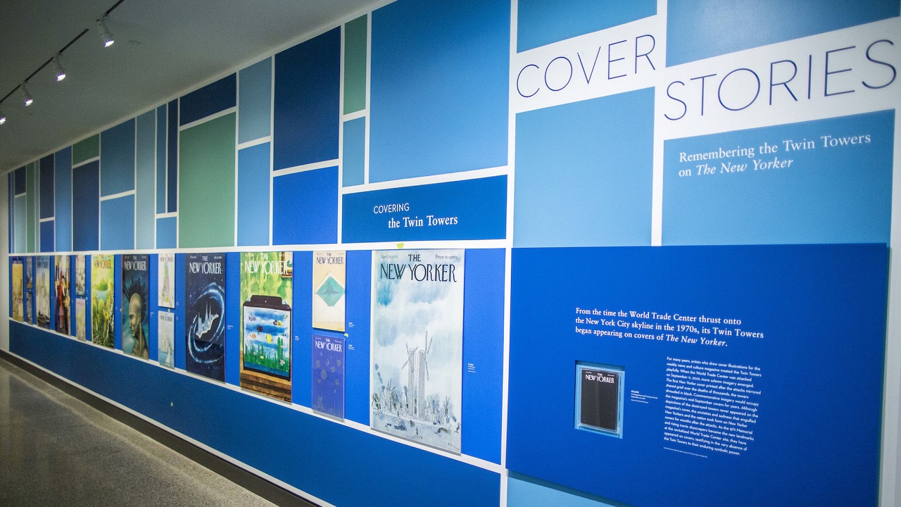 Images of Twin Towers–themed New Yorker covers are displayed on a wall as part of the exhibition Cover Stories.