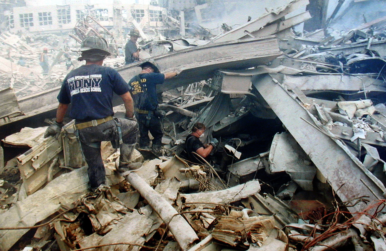 FDNY members climb debris at Ground Zero