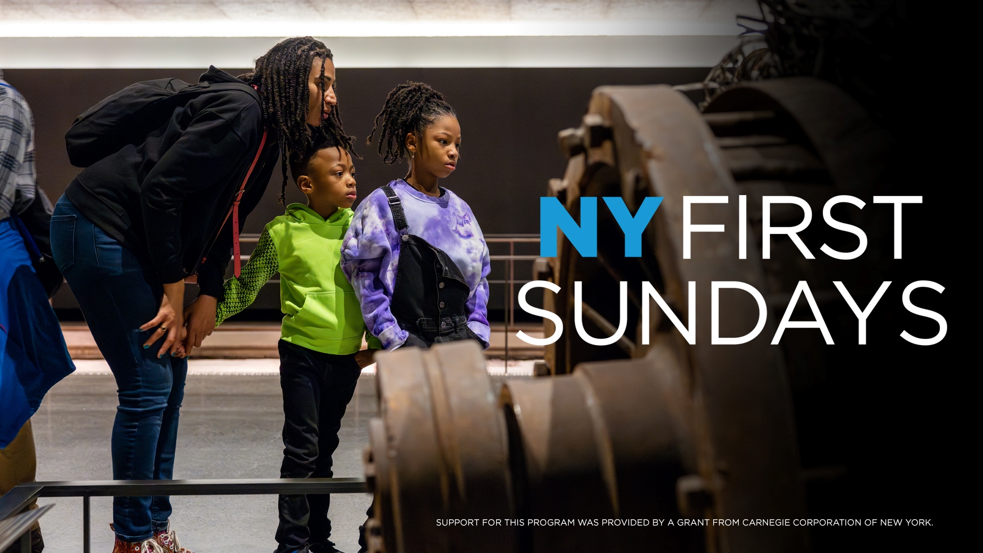 An adult leans down to talk to two children as they view an artifact. "NY First Sundays" overlays the artifact. Support for this program was provided by a grant from the Carnegie Corporation of New York.