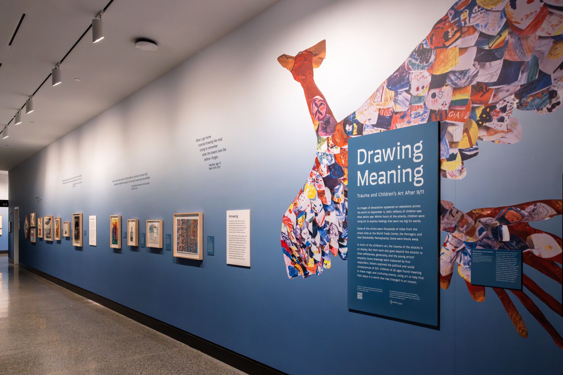 Exhibition wall displaying several framed artworks.