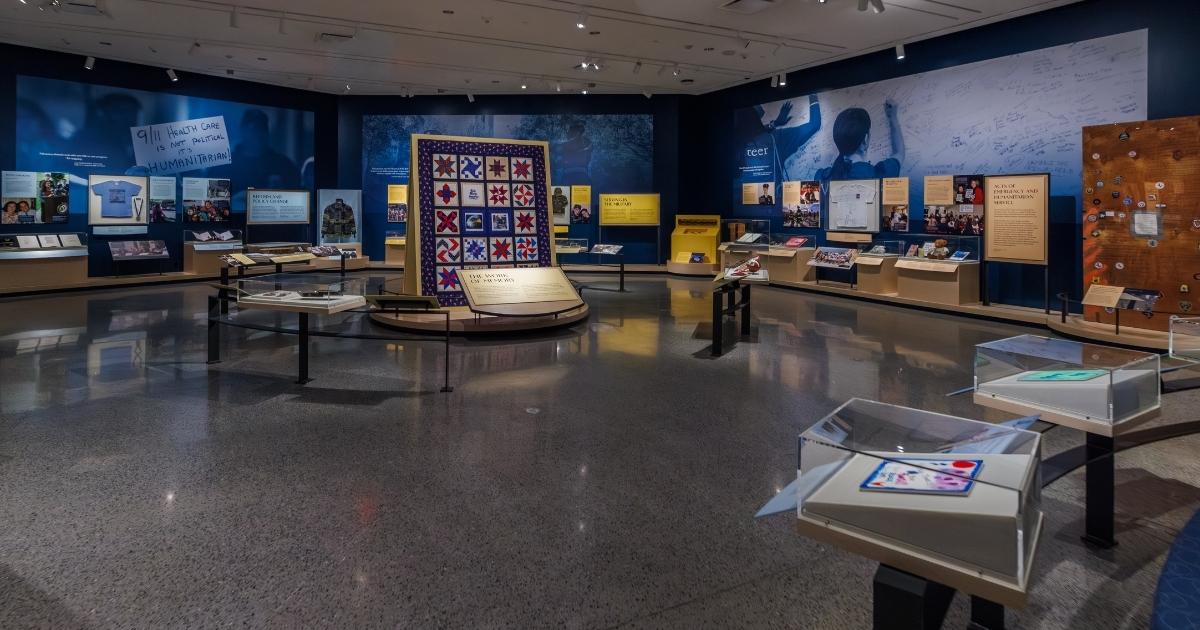 Panorama of a Museum exhibition with a decorative quilt at the center