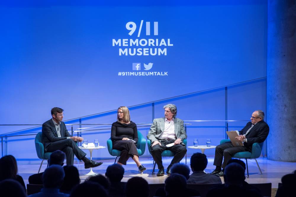 Handel Architects LLP partner Michael Arad, Paul Murdoch Architects President Paul Murdoch, and KBAS partner Julie Beckman sit onstage in the Museum Auditorium. Clifford Chanin, the executive vice president and deputy director for museum programs, sits to their left holding a clipboard. The 9/11 Memorial & Museum logo is projected on the wall above them.