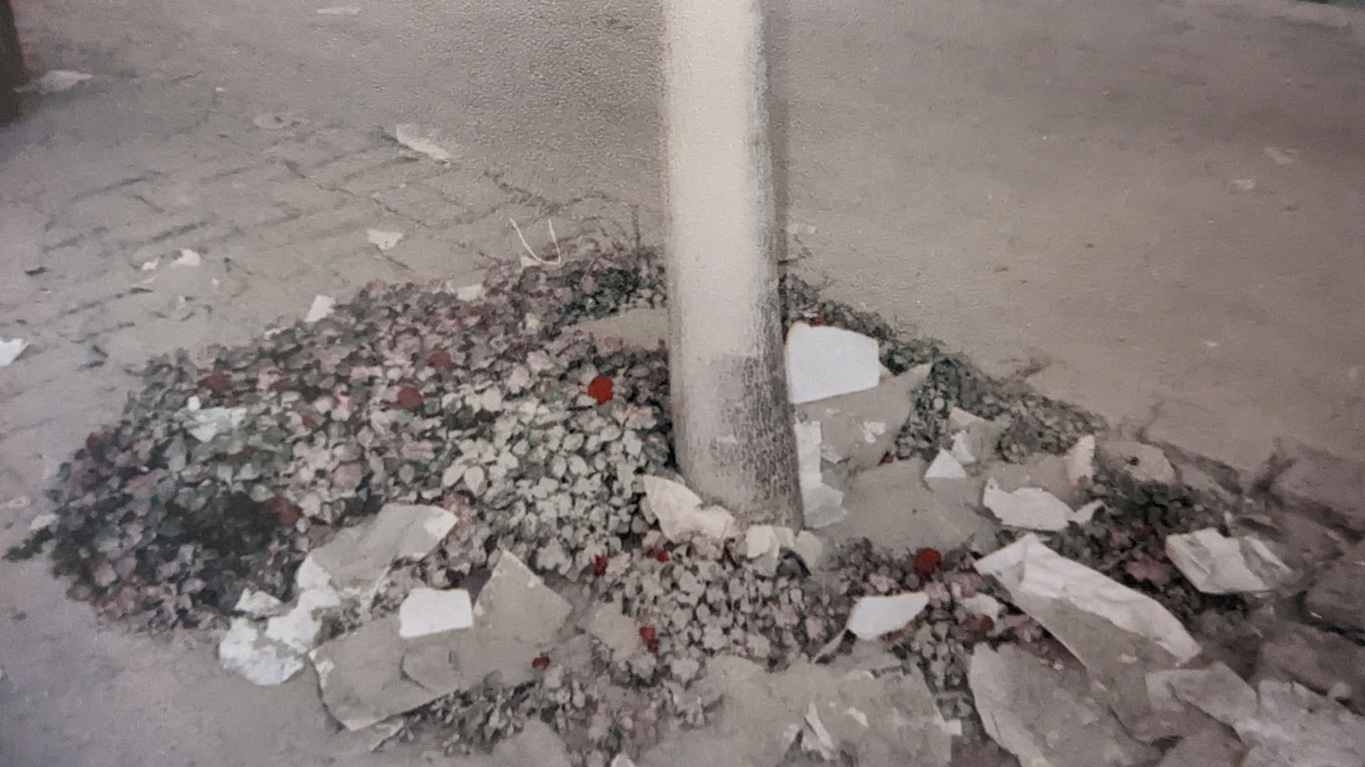 A pole juts out of a pile of rubble
