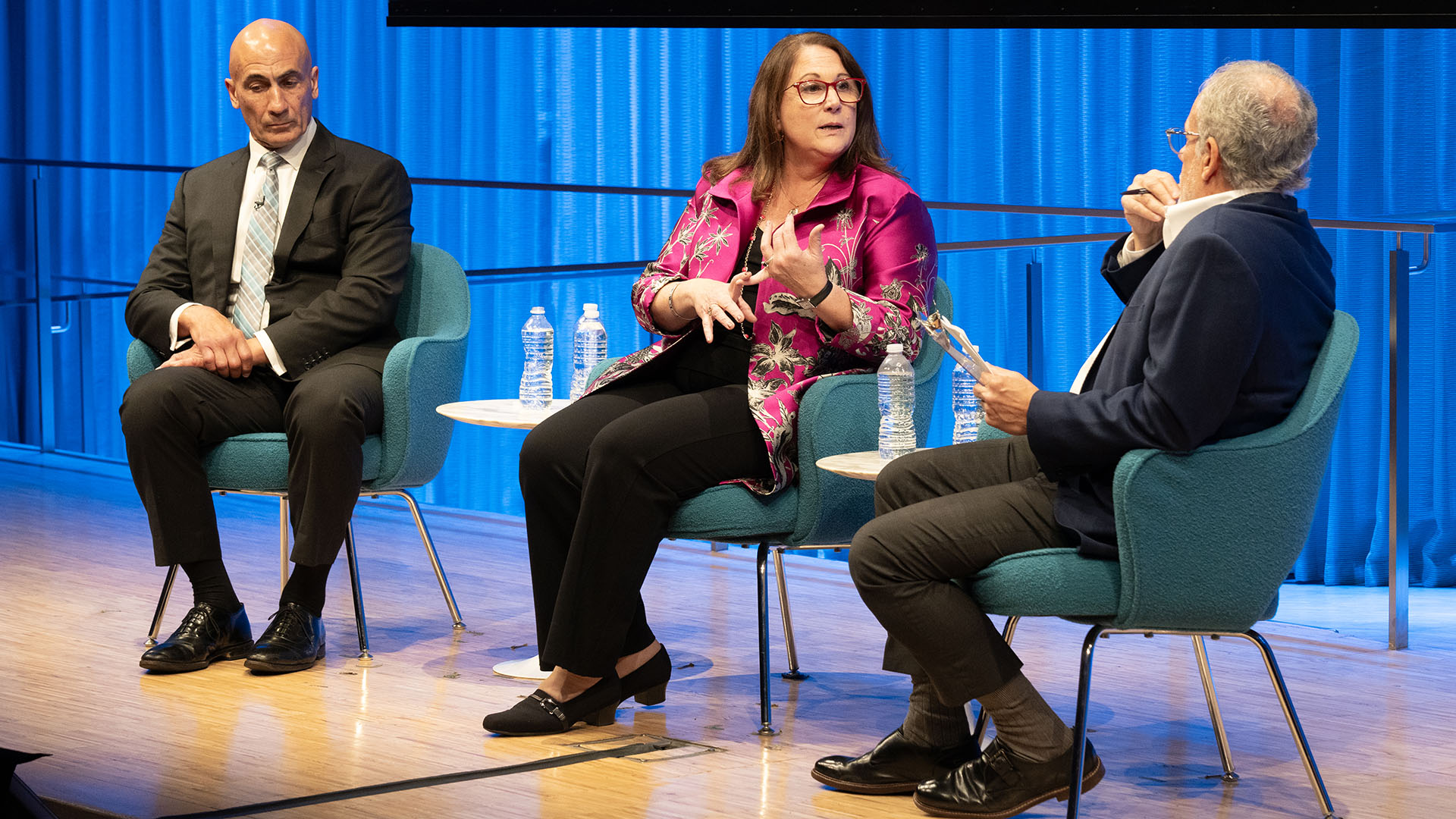 From left: John Liguori, Mary E. Galligan (talking) and Clifford Chanin on stage