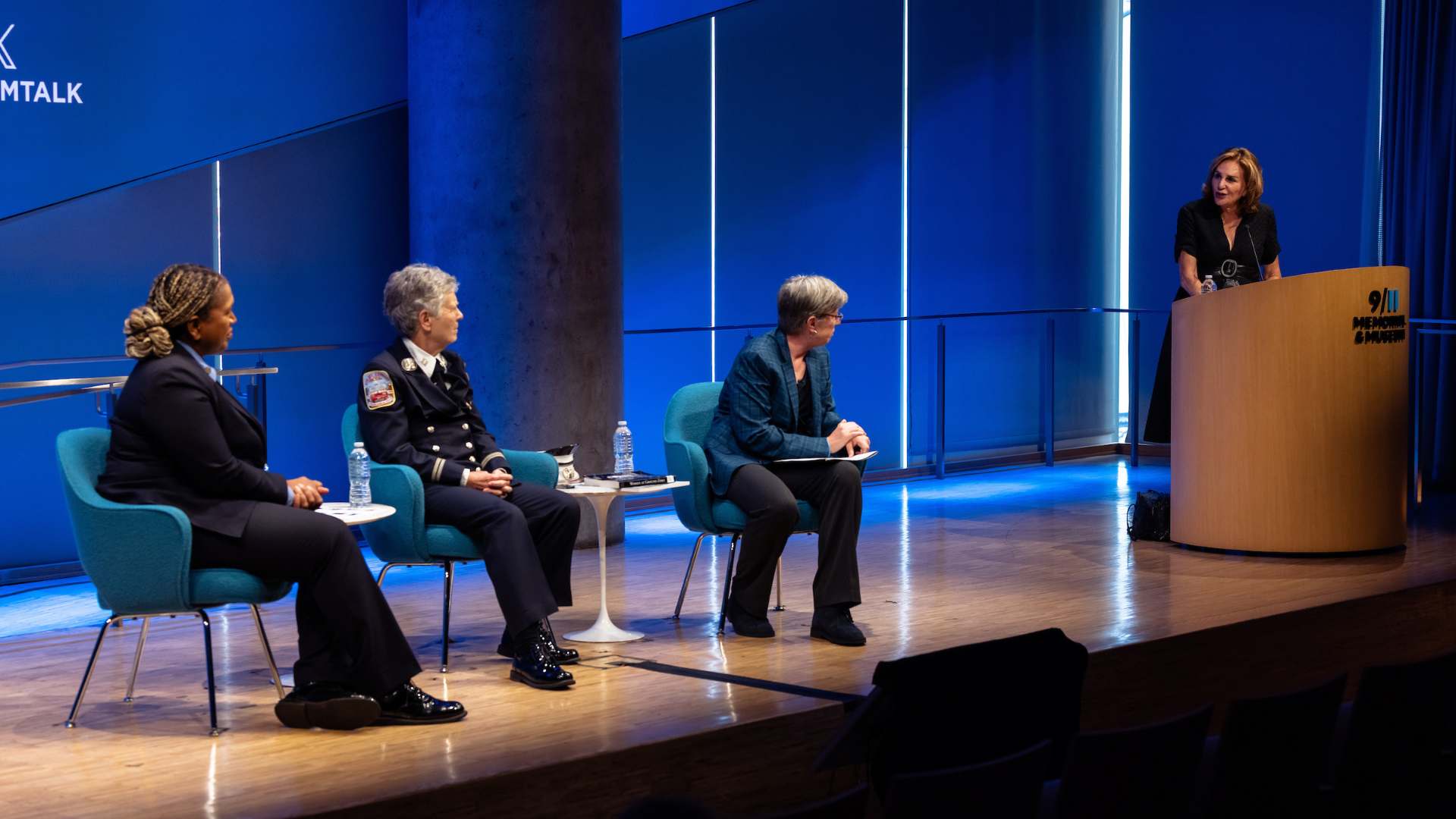 Brenda Berkman, Regina Wilson, and Beth Hillman are turned from the camera towards the moderator