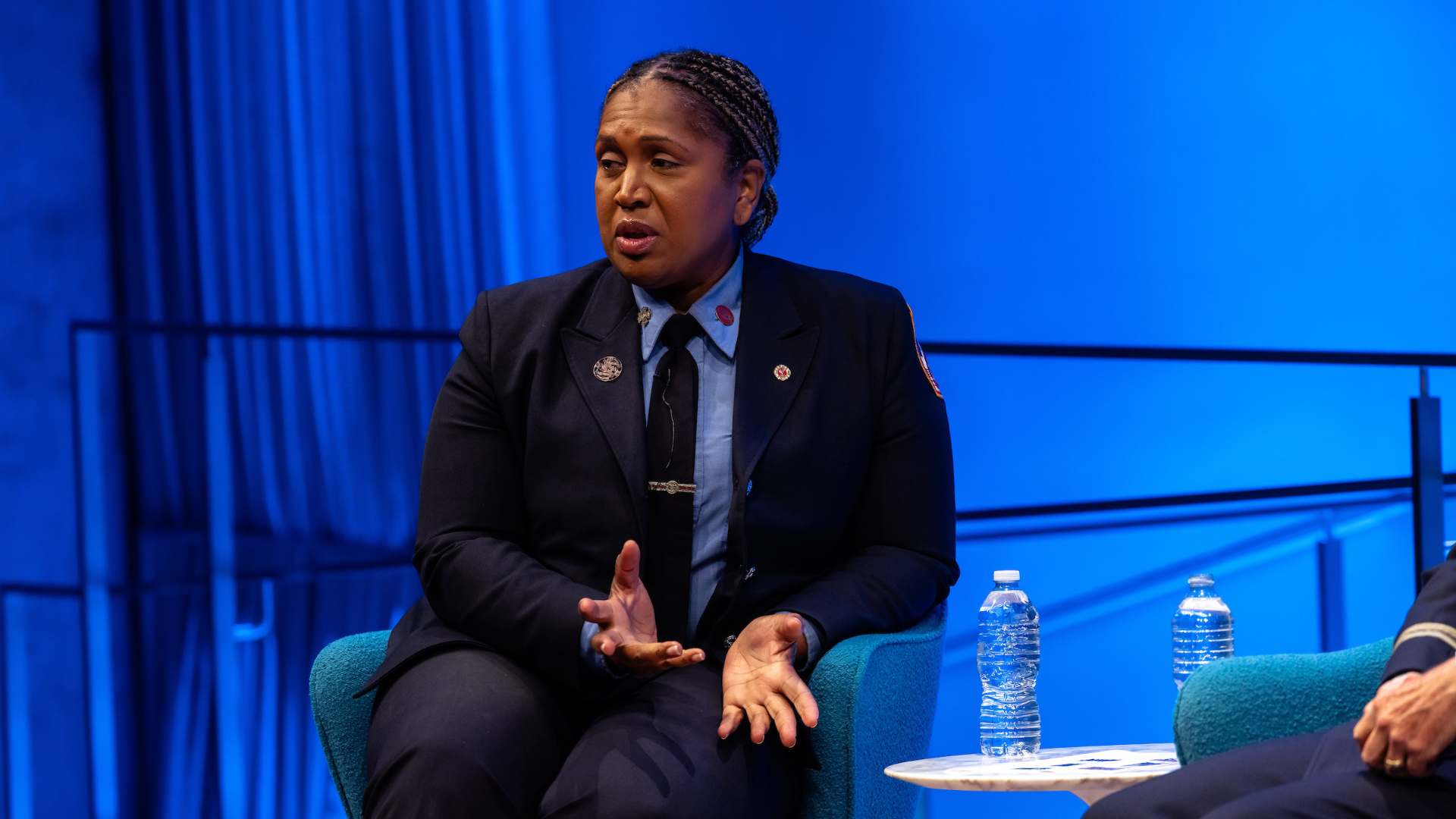 Regina Wilson gestures with two hands speaking to the audience