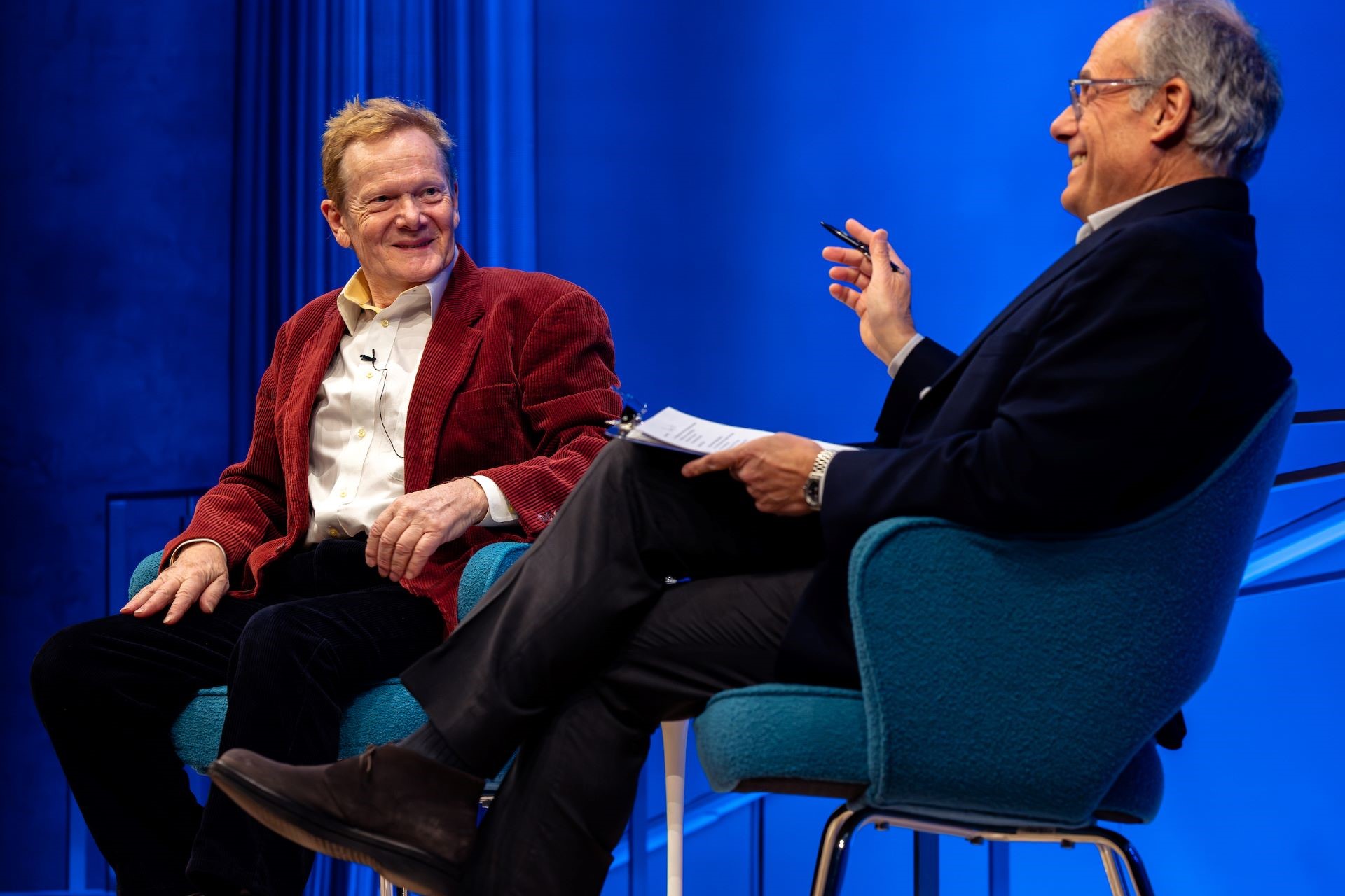 Closeup of Philippe Petit and Clifford Channing, who is talking and gesturing