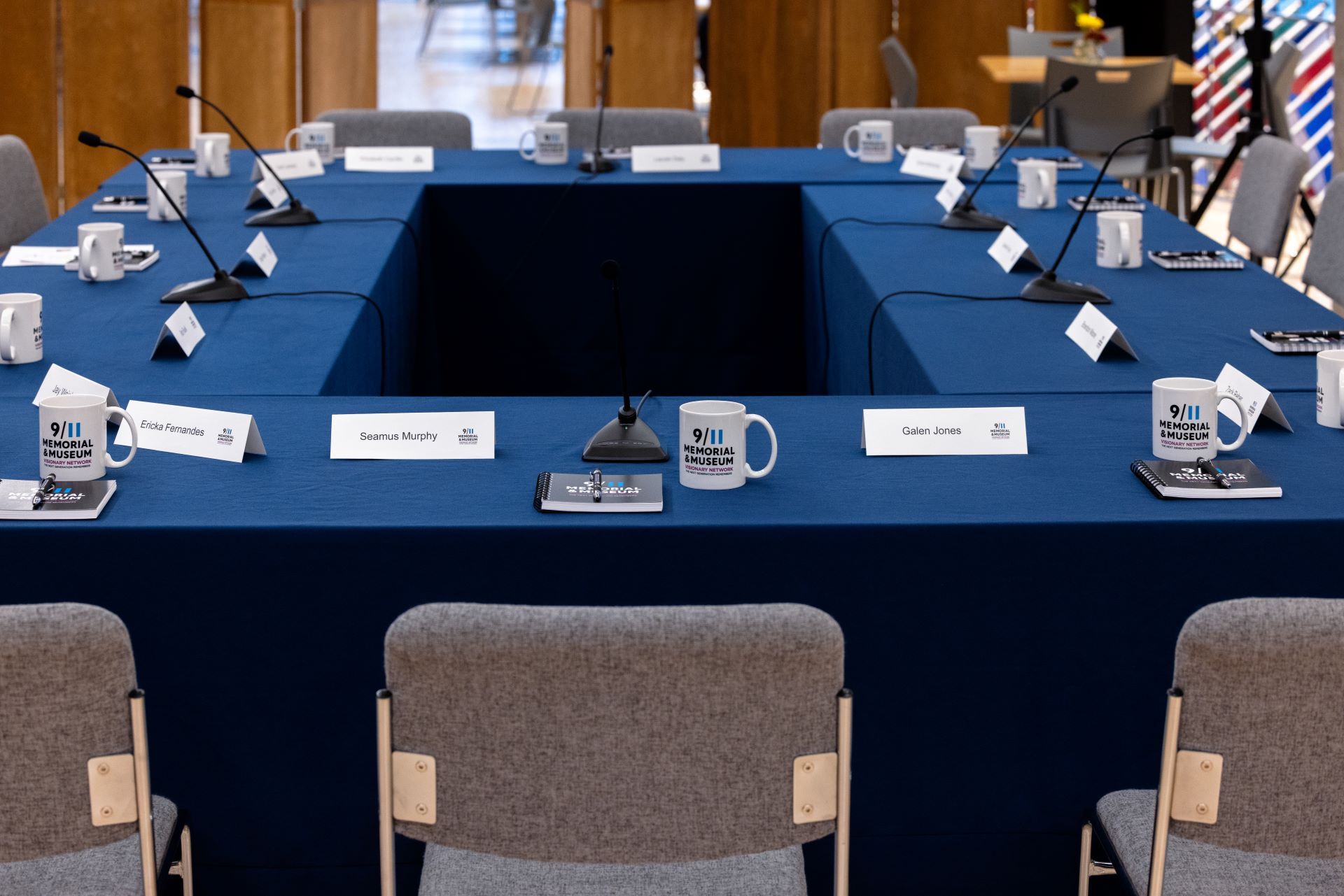 a square blue table set with name tags