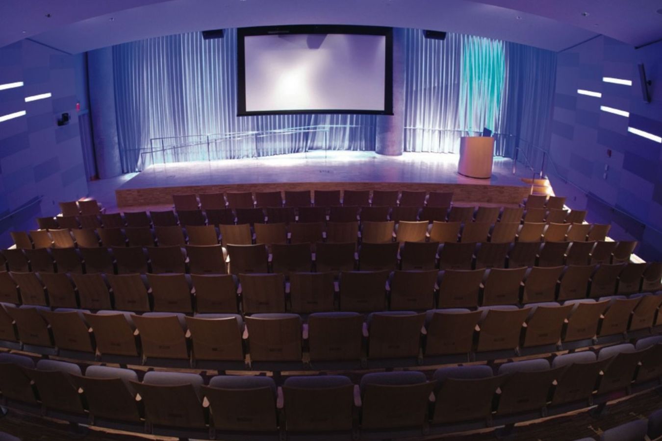 Auditorium open view from back with stage and seating visible