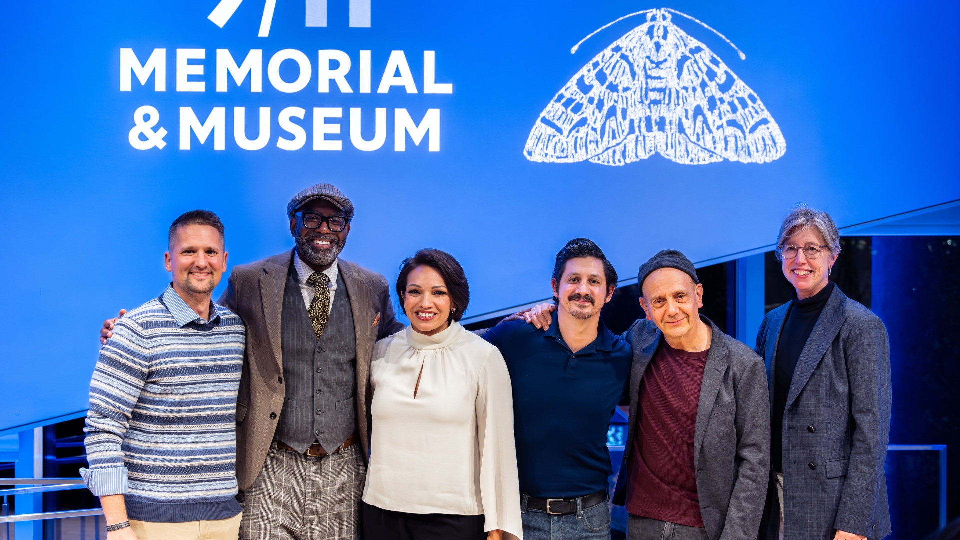 The MOTH cast stands in a line with President Beth Hillman.