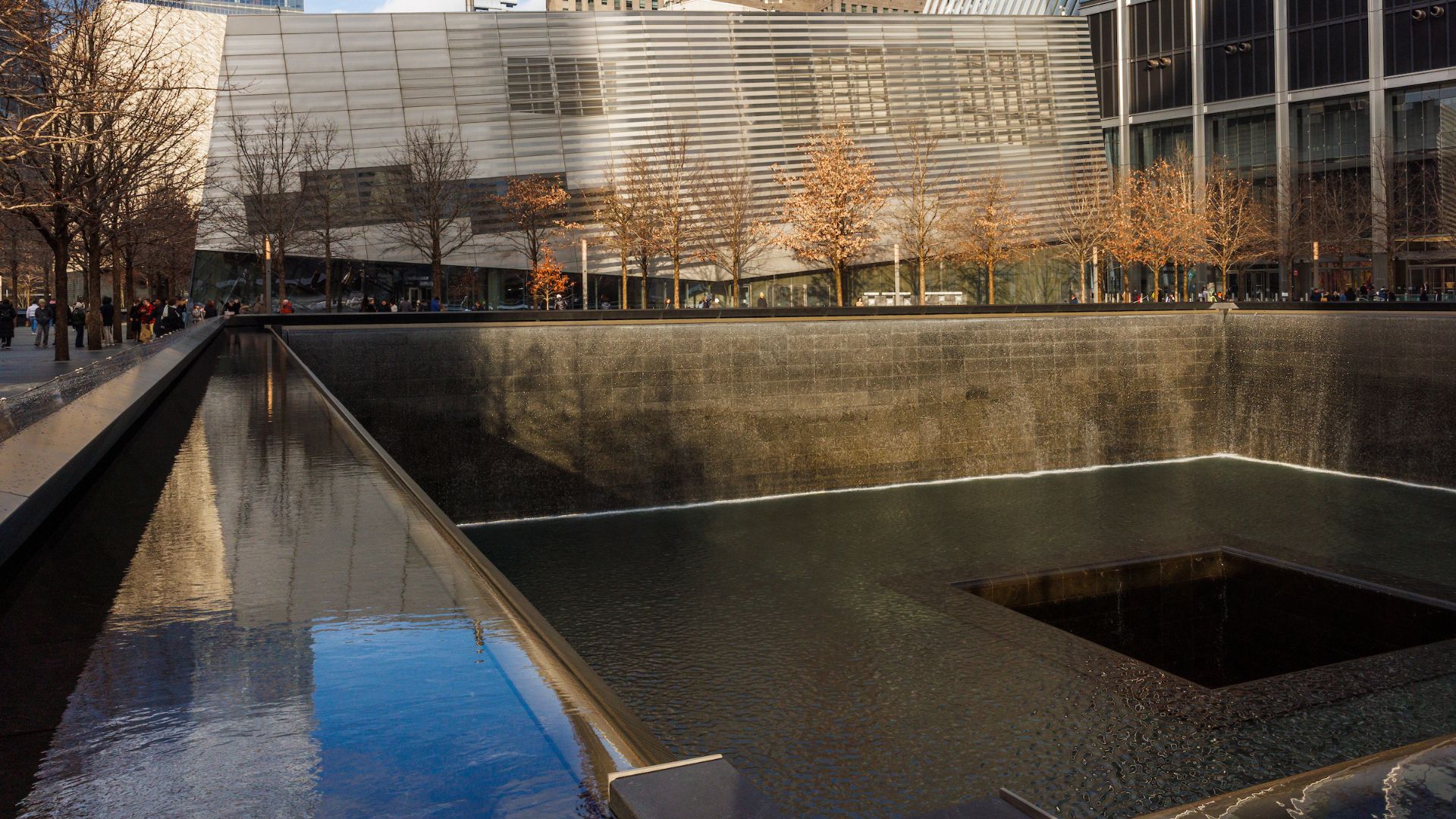 Fall foliage lines a reflecting pool at the Memorial