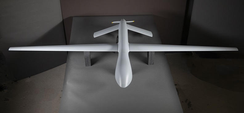 White model of a drone with long narrow wings. 