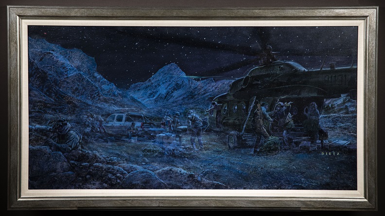 Monochromatic painting in shades of blue, green, and black depicting soldiers carrying supplies from a helicopter to a truck on a rocky terrain at night. 