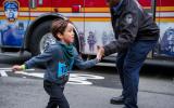 Kid running high fives a first responder