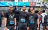 Three men celebrating the race at the finish line