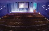 Auditorium facing stage with seats visible from AV room in back