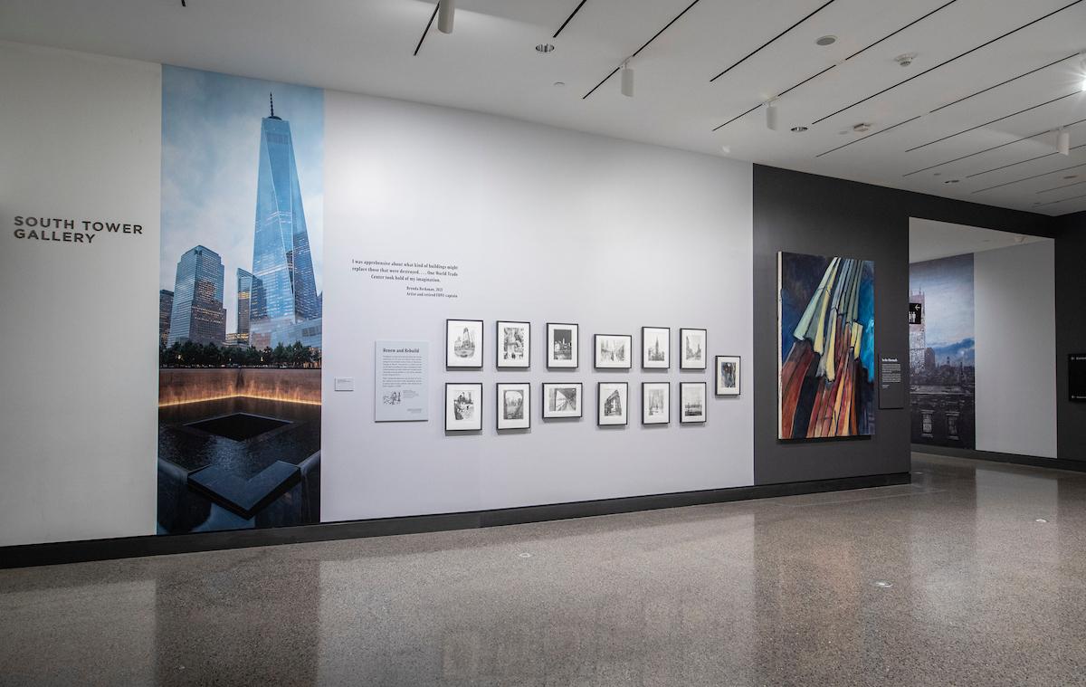 Beginning of exhibition along wall in the South Tower Gallery, showing the new One World Trade Center and rows of additional artwork