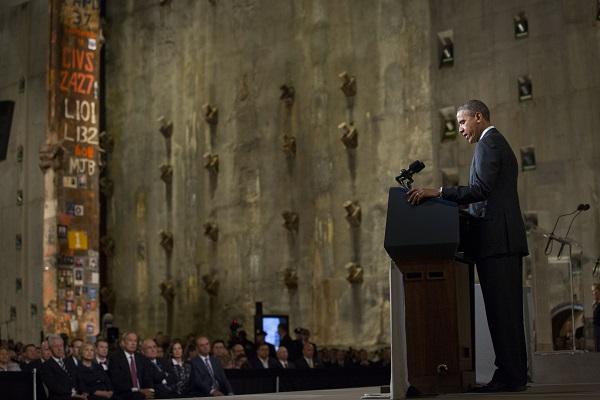 Former President Barack Obama speaks in Foundation Hall during the 9/11 Memorial Museum’s dedication ceremony. Officials including former President Bill Clinton and former Mayor Rudy Giuliani watch on from the crowd.