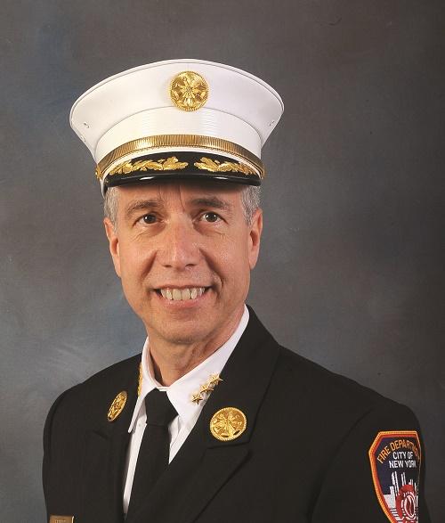 FDNY Chief Joseph Pfeifer smiles as he poses for an official photo in his formal FDNY uniform.