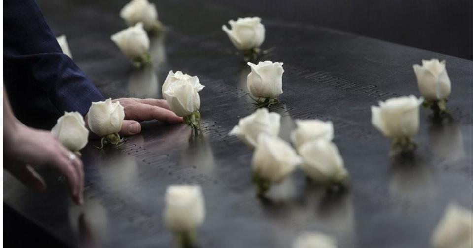 White roses in the names on the Memorial parapet