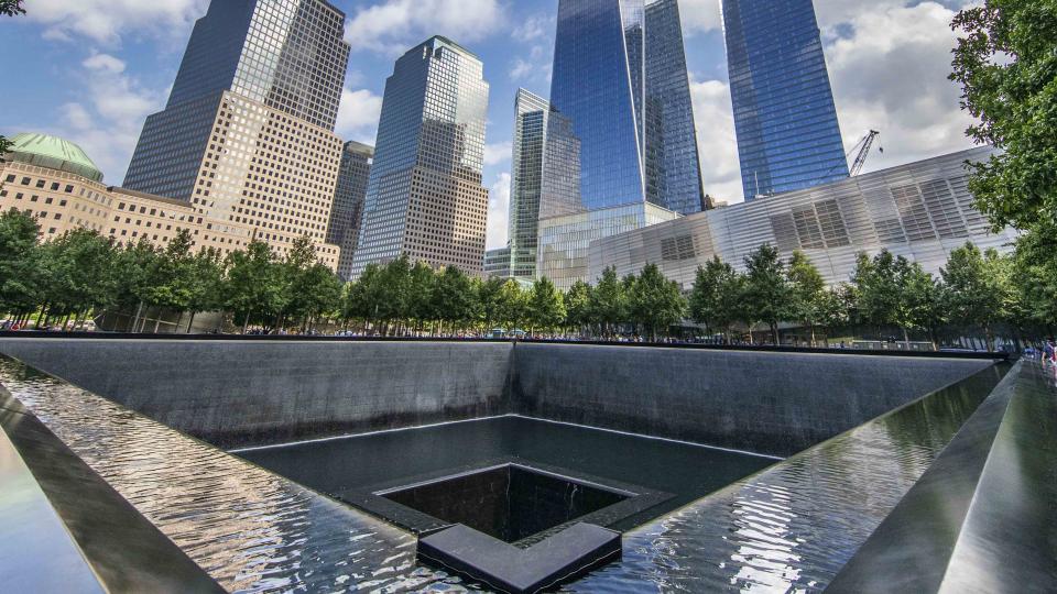 This panoramic shot is taking from southeast corner of the north pool of the Memorial, looking northward and upward toward the soaring One World Trade.