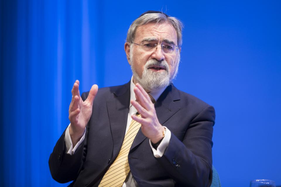 Rabbi Jonathan Sacks, who had retired as chief rabbi of the United Hebrew Congregations of the British Commonwealth when he visited the 9/11 Memorial Museum in 2016, raises both his hands as he gestures during a talk about interfaith understanding.  