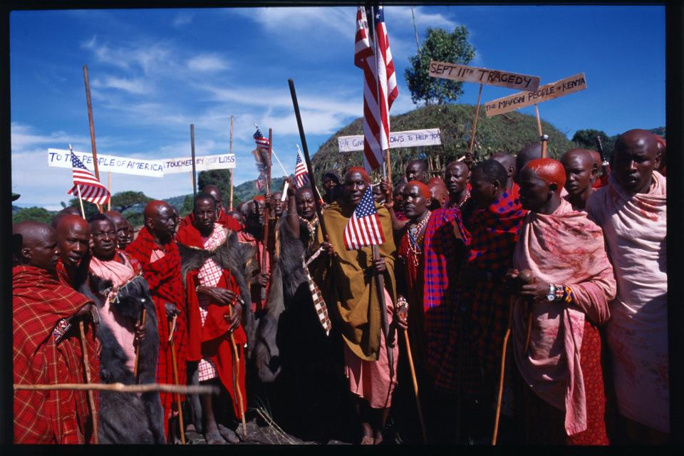 A group of Maasai carry American flags and signs showing their support after the attacks.