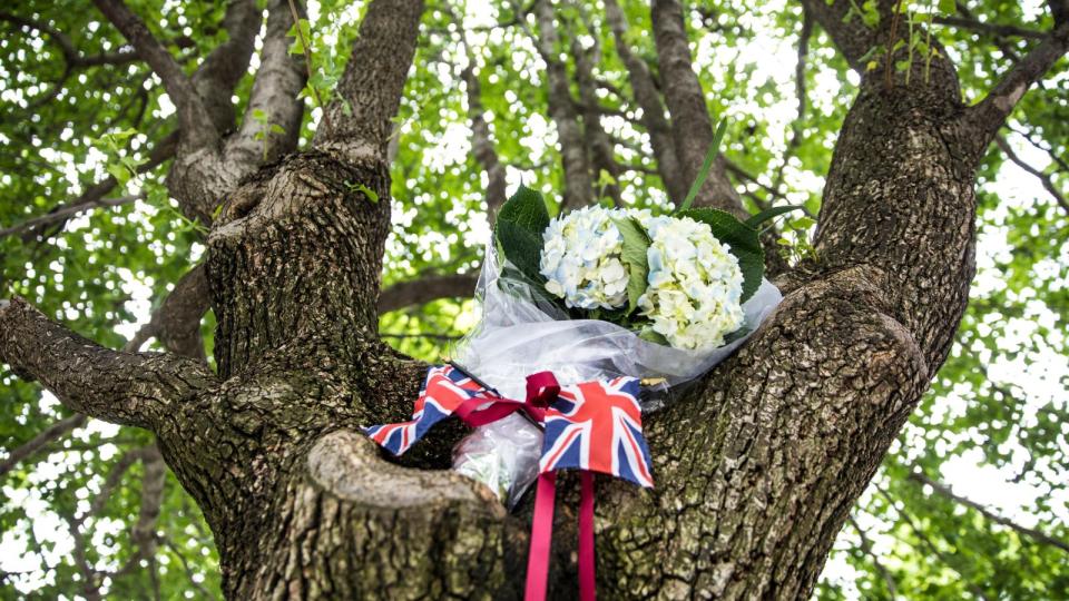 Flowers and a British flag left in tribute at Survivor Tree